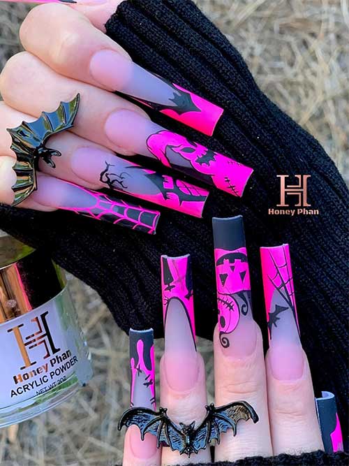 Long matte black and hot pink French tip nails featuring Oogie Boogie art, bats, spider webs, and pumpkins.