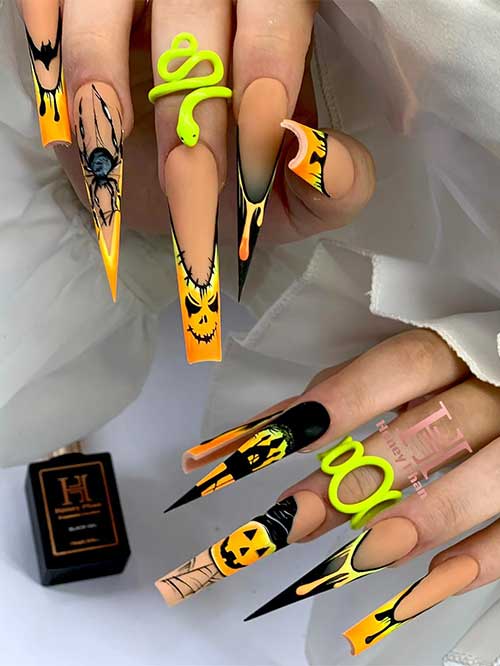 Long square matte nude nails with ombre neon tips, black drip art, 3D spider, pumpkin face, and cemetery accents.