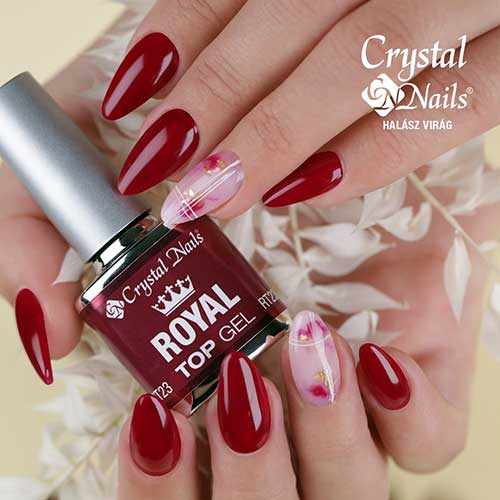 Medium almond-shaped burgundy nails with a milky white accent nail featuring white line art and burgundy patches with gold foil.