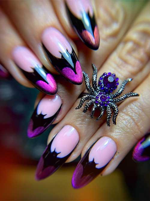 Sparkling purple and black cat eye French tip nails adorned with black bats, creating a festive Halloween look.