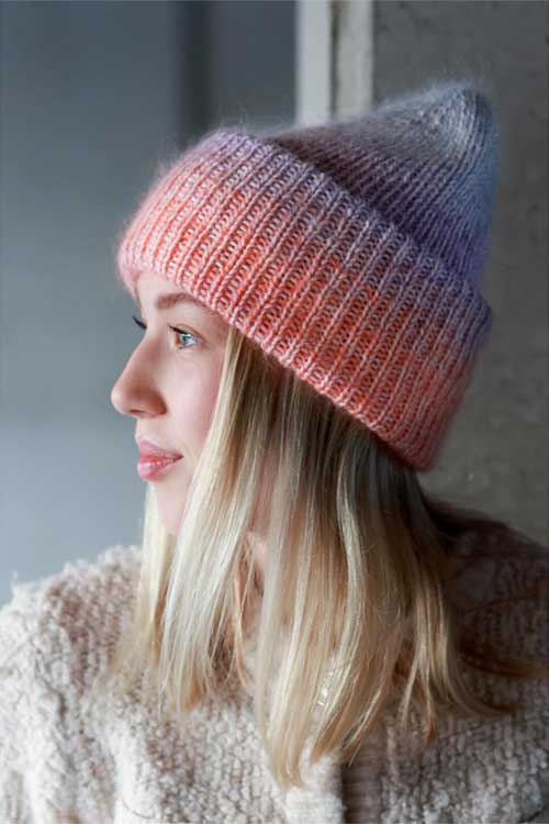 A stylish textured lob hairstyle complemented by a cozy beanie, showcasing a modern and chic look.