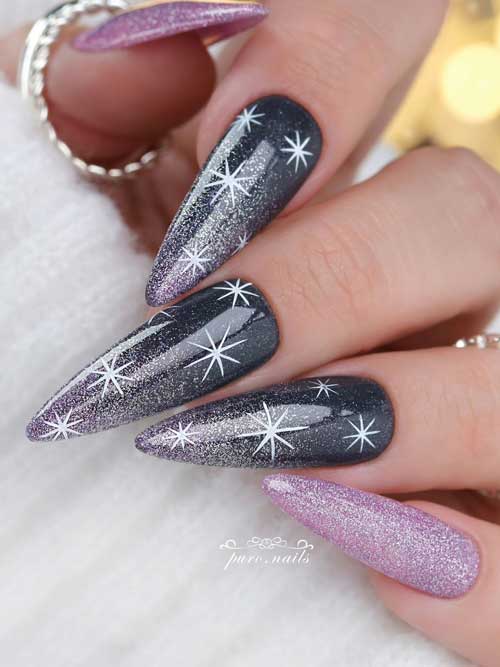 Dark grey winter nails adorned with light purple glitter and white snowflakes, complemented by two accent light purple glitter nails.