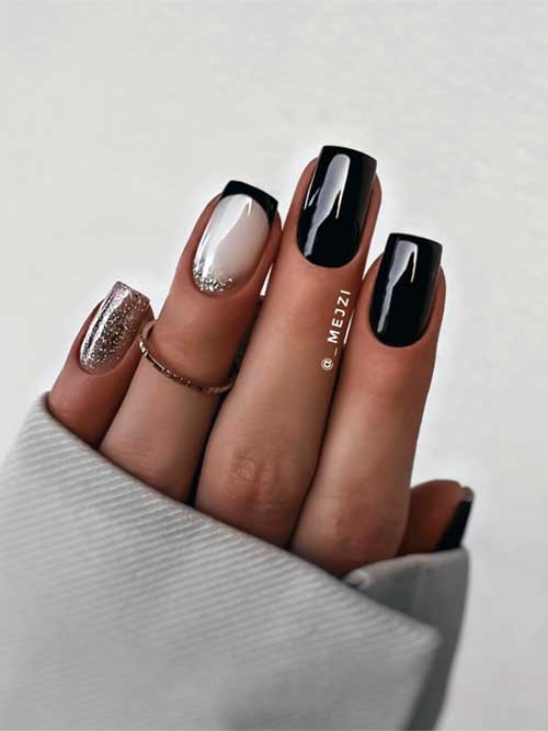 Short fall black nails with an accent black French tip on a milky white base, featuring gold glitter above the cuticle.