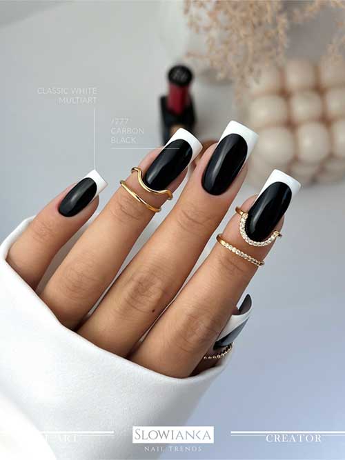 Stylish square black nails adorned with white French tips, ideal for autumn aesthetics.