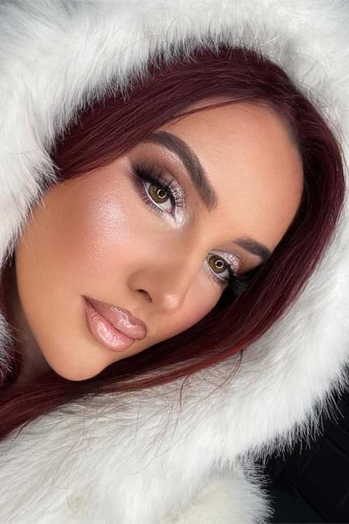 A festive makeup look showcasing icy smoky eyes paired with nude lips, perfect for a shimmering Christmas celebration.