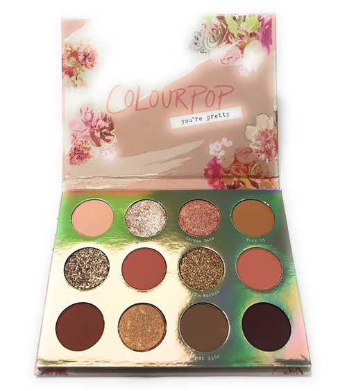 A vibrant eyeshadow palette featuring warm tones and a variety of finishes, perfect for creating stunning eye looks.