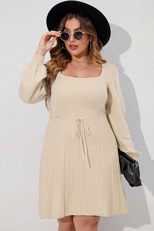 Casual plus size sweater dress for women, designed with a square neck, long lantern sleeves, and a comfortable tie waist.