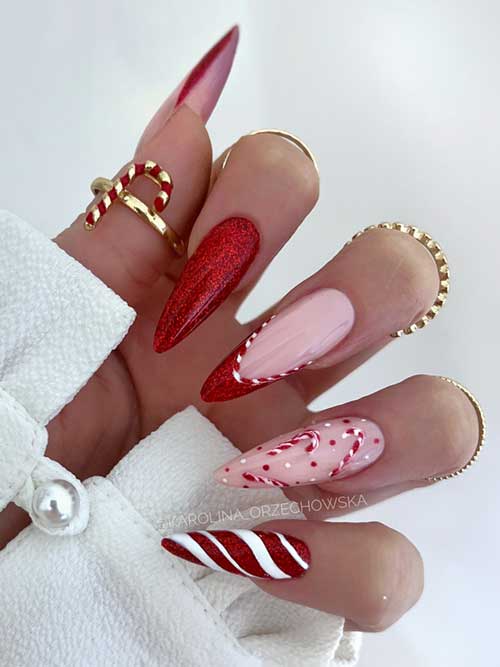 Glittery red Christmas nails adorned with candy cane art and two elegant accent French tips.