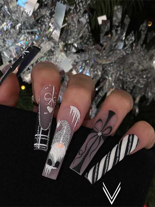 Long black Christmas nails adorned with silver glitter Santa, candy cane, plaid designs, and festive present art.