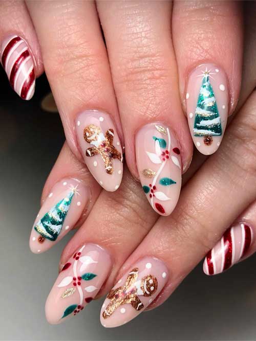 Nude cute Christmas nails featuring festive designs like a Christmas tree, candy cane, and gingerbread art.