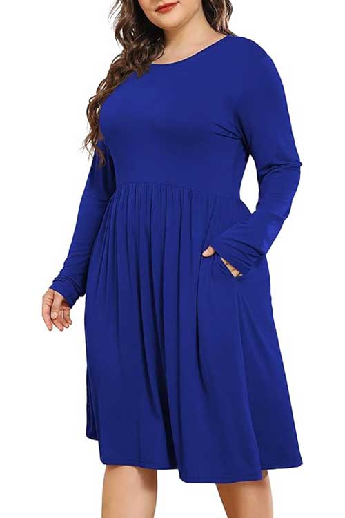 Plus size women's casual dress with long sleeves, crew neck, empire waist, and pockets; loose and flowy design for comfort.