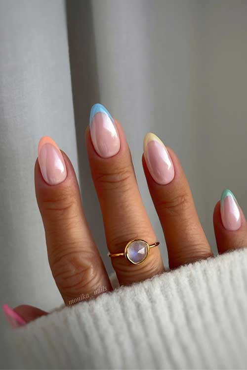 A vibrant French nail design with pastel gradient tips in peach, blue, yellow, and green for a fresh, colorful look.