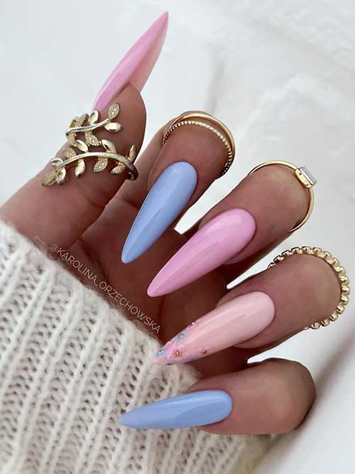 Elegant long nails in pastel pink and blue, featuring a gradient and sparkles, paired with stylish rings for a chic look.