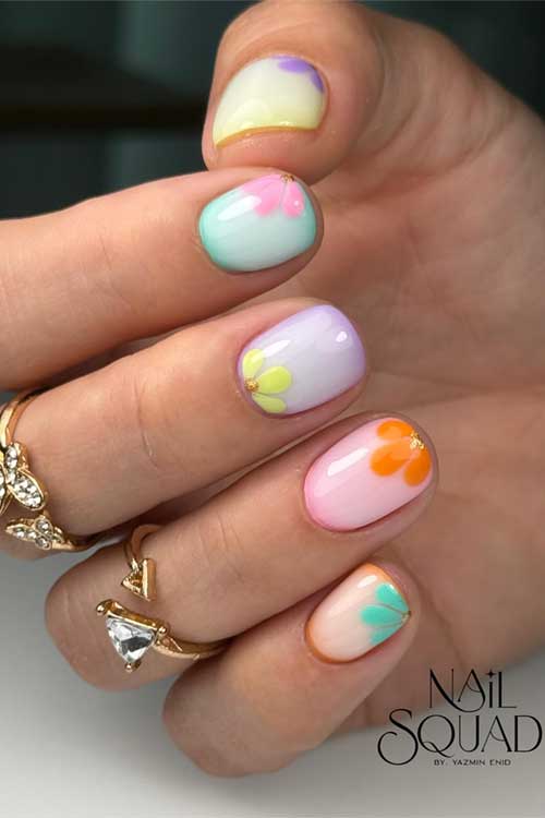 Soft pastel spring nails with unique colors and intricate floral designs, accented with gold.