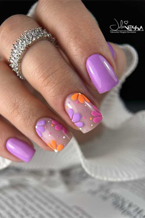 Vibrant lavender nails with two floral accent nails featuring purple and orange petals, perfect for a fresh spring look